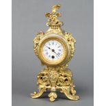 A 19th Century French timepiece with painted dial and Roman numerals, contained in a gilt metal