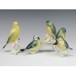 Karl Ens, a German figure group of 4 birds on a branch and ditto budgerigar on a stump 13cm
