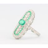 A platinum Edwardian style emerald and diamond up-finger ring, the emeralds approx. 0.78ct, diamonds