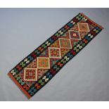 A black, turquoise and orange ground Chobi Kilim runner 202cm x 64cm