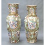A near pair of massive mid 20th Century oviform famille rose vases with twin lion handles, decorated