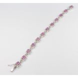 An 18ct white gold pink sapphire and diamond Art Deco style bracelet, the pink sapphires approx.