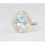 A platinum Edwardian style oval aquamarine and diamond cluster ring, the centre stone approx 1.7ct