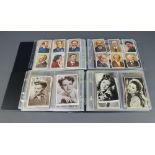 An album of black and white postcards of actresses and other postcards together with a red loose