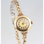 A lady's 9ct yellow gold wristwatch contained in a 25mm case on an expanding gilt bracelet This