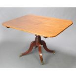 A Regency rectangular mahogany breakfast table raised on a turned column and tripod base with