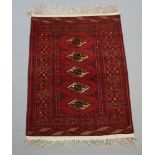 A red and blue ground Bokhara rug with 5 diamonds to the centre within a multi row border 118cm x