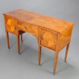 An Edwardian satinwood bow front wash stand with 1/4 veneered top, fitted a drawer flanked by a pair