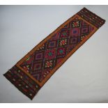 A Suzni brown and blue ground Kilim runner with diamond decoration 258cm x 74cm