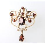 A Victorian style 9ct yellow gold open scroll brooch pendant, set with garnets and pearls 40mm, 6.
