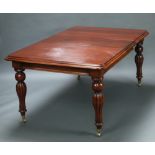 A Victorian style mahogany extending dining table with 2 extra leaves, raised on turned and reeded