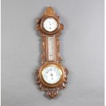 A Victorian wheel aneroid barometer and thermometer with porcelain dial contained in a carved oak
