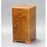 An Art Deco figured walnut bedside cabinet fitted a drawer above panelled door 69cm h x 35cm w x