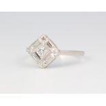 A platinum diamond ring with centre old cut stones, surrounded by baguette and brilliant cut