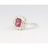 A platinum pink tourmaline and diamond cluster ring, the centre stone surrounded by brilliant and