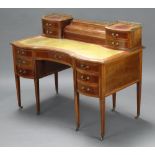 An Edwardian inlaid mahogany writing table, the super structure fitted a stationery box enclosed