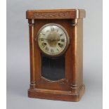 An Edwardian Art Nouveau 8 day striking mantel clock with silvered dial and Roman numerals contained