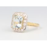 An 18ct yellow gold aquamarine and diamond cluster ring, the centre stone approx. 2.5ct surrounded