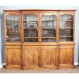 A Victorian rosewood triple breakfront bookcase, the upper section with moulded cornice fitted