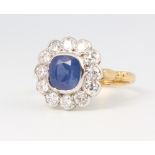 An 18ct yellow gold sapphire and diamond cluster ring, the centre stone approx. 2.2ct surrounded