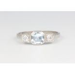 A platinum Edwardian style 3 stone ring, the centre aquamarine flanked by 2 brilliant cut diamonds