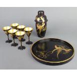 An Art Deco Chinese black lacquered 9 piece cocktail set comprising circular tray 27cm diam.,