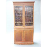 An Edwardian Sheraton style inlaid mahogany display cabinet on cabinet, the shelved upper section