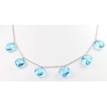 An 18ct white gold necklace set with 6 blue glass drops with matching gilt earrings