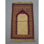 An Israeli purple, pink and green ground prayer rug 87cm x 50cm, the reverse marked Palestinian