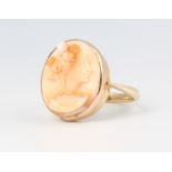 A 9ct yellow gold carved coral portrait ring, size K 1/2, 4.5 grams