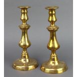 A pair of 19th Century polished brass candlesticks, 1 with ejector, 27cm h x 12cm