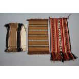A brown and white saddle bag 55cm x 32cm, a brown, black and white slip rug 75cm x 43cm, a multi