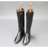 A pair of black leather riding boots complete with beech and metal sprung trees Signs of old but