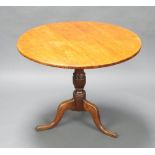 A Georgian circular light oak snap top tea table, raised on turned column and tripod base 70cm h x