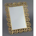 A 19th Century rectangular plate easel mirror contained in a pierced brass rococo style frame 38cm x
