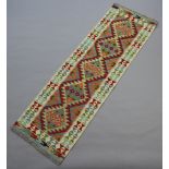 A white, yellow, green and turquoise ground Chobi runner with all over geometric designs 193cm x