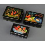 A rectangular Russian papier mache trinket box with hinged lid 4cm x 8cm x 10cm and 2 others 3cm x