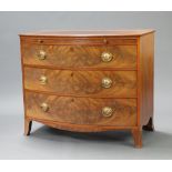 A Georgian bleached mahogany bow front chest with brushing slide above 3 long drawers, raised on