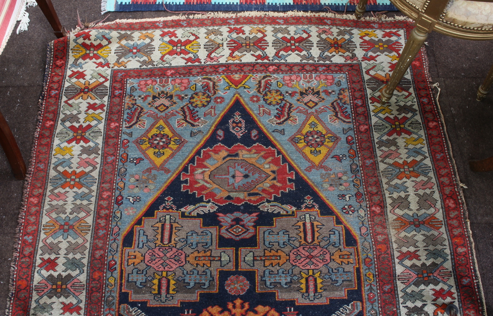 A North West Persian red and blue ground rug with shaped medallion to the centre within a multi - Image 2 of 5