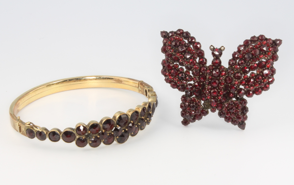 A Victorian gilt garnet set bangle together with a ditto butterfly brooch