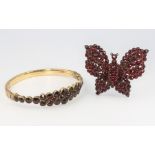 A Victorian gilt garnet set bangle together with a ditto butterfly brooch