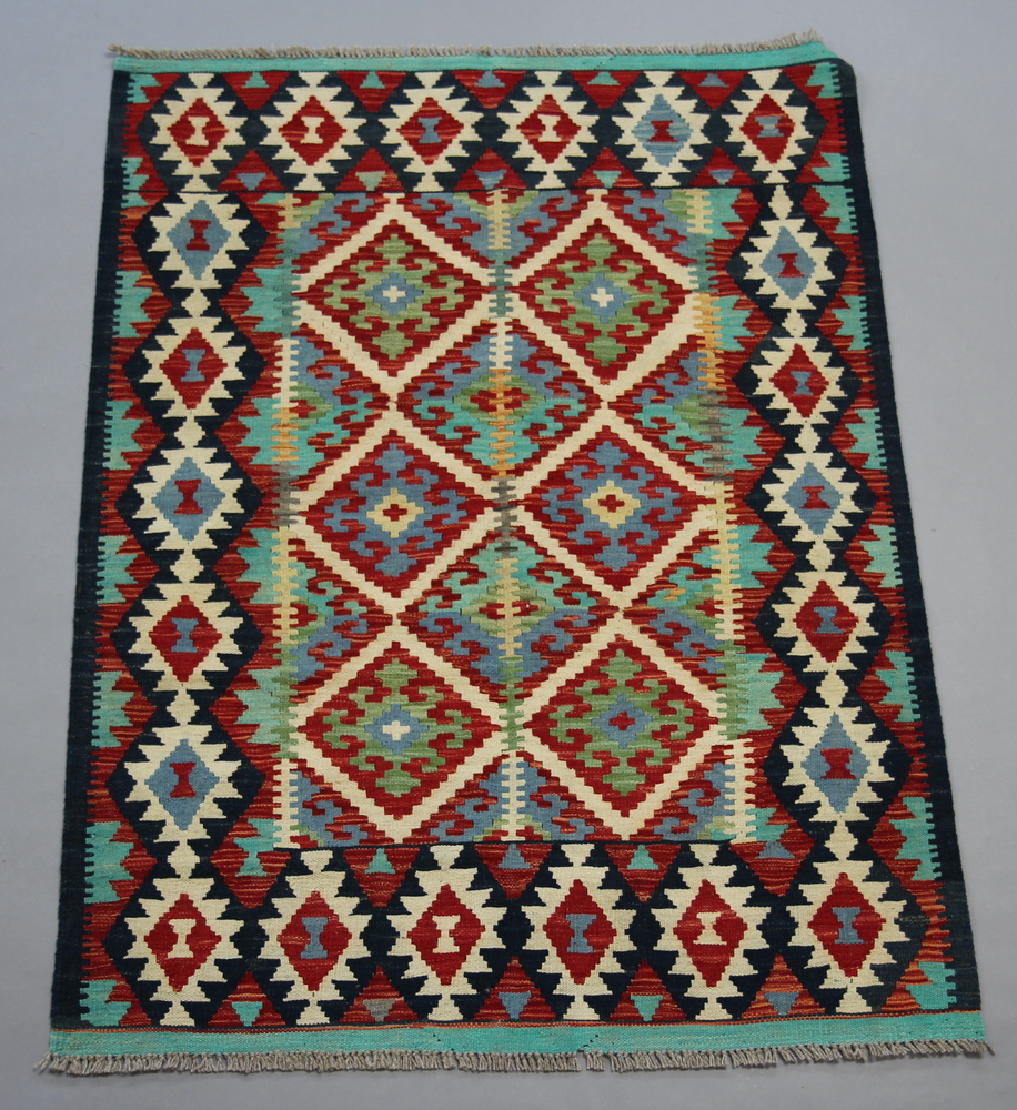 A white, green and turquoise ground Chobi Kilim rug with overall geometric design 146cm x 109cm