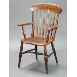 A 19th Century elm and beech stick back Windsor carver chair with solid elm seat raised on turned