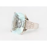 A white metal stamped 18k cushion cut aquamarine and diamond ring, the centre stone 21mm x 17mm x
