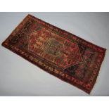 A red and blue Afghan rug with central medallion 201cm x 102cm Signs of old moth