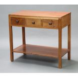 An Art Deco, Heals style, mahogany side table fitted 3 short drawers above undertier, raised on