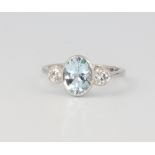 A platinum aquamarine and diamond ring, the centre oval cut stone 1.75ct, the 2 brilliant cut