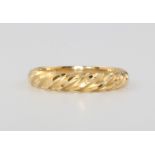 An 18ct yellow gold bright cut ring, size P, 2.6 grams