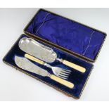 A Victorian cased silver plated pair of fish servers and crumb scoop The box is broken