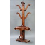 A Victorian mahogany hat and coat hall stand, the base fitted a glove box of serpentine outline,